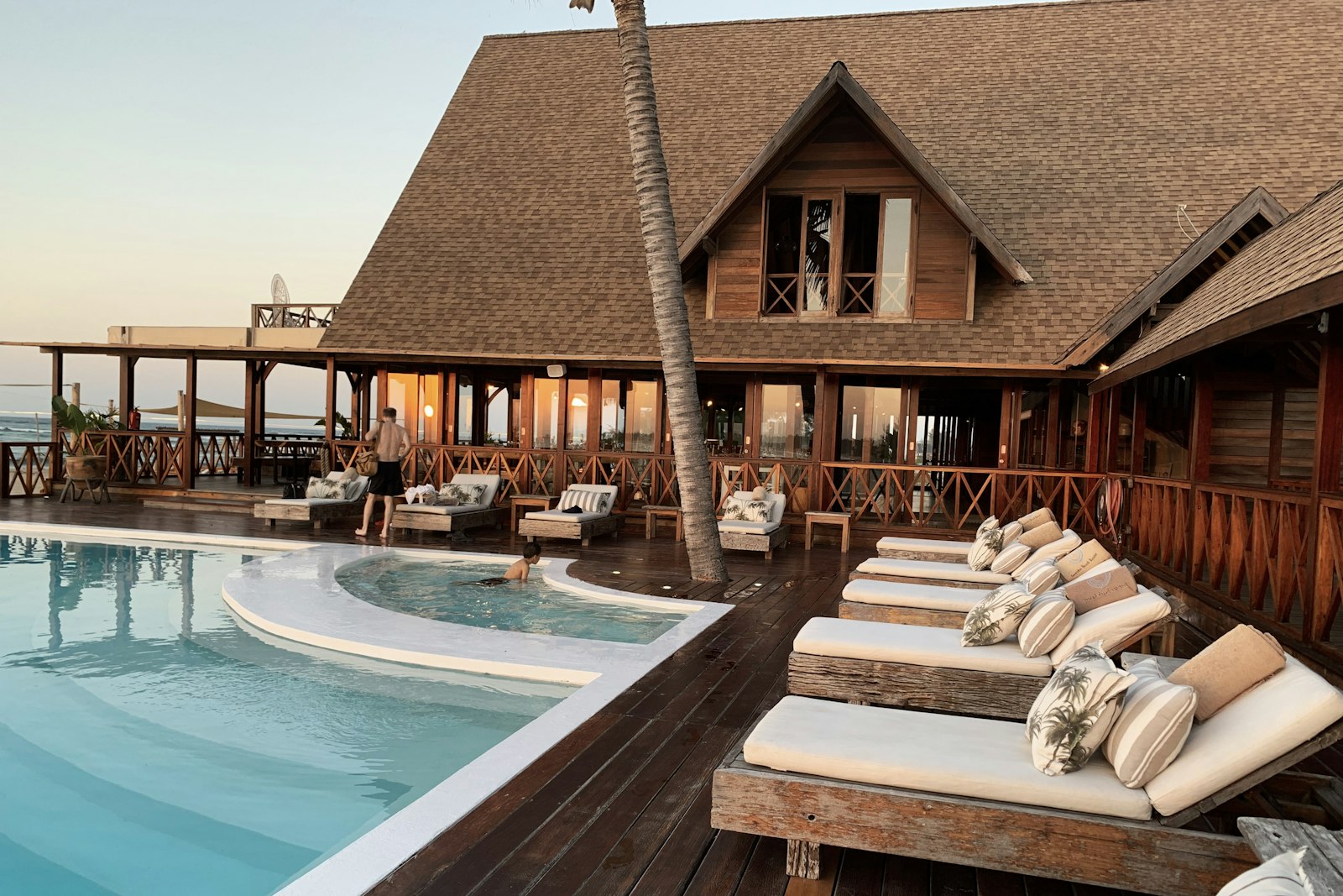 Illustrative photo: a resort hotel pool in warm evening light